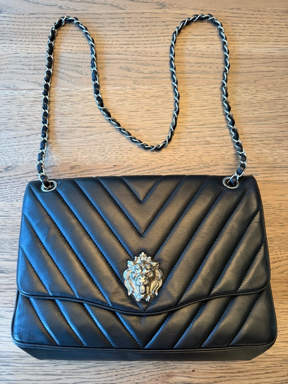CHANEL Black Quilted Shoulder Bag with Lion Head Accent